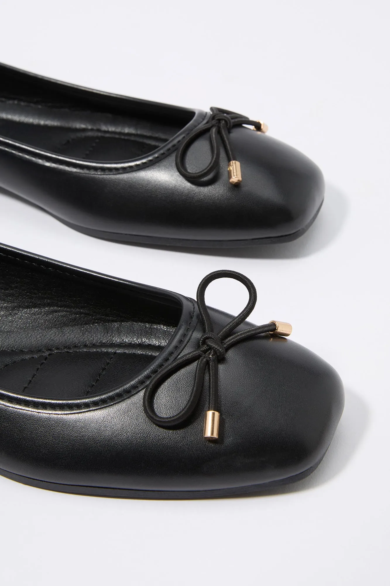 Faux leather ballet flats with buckles.