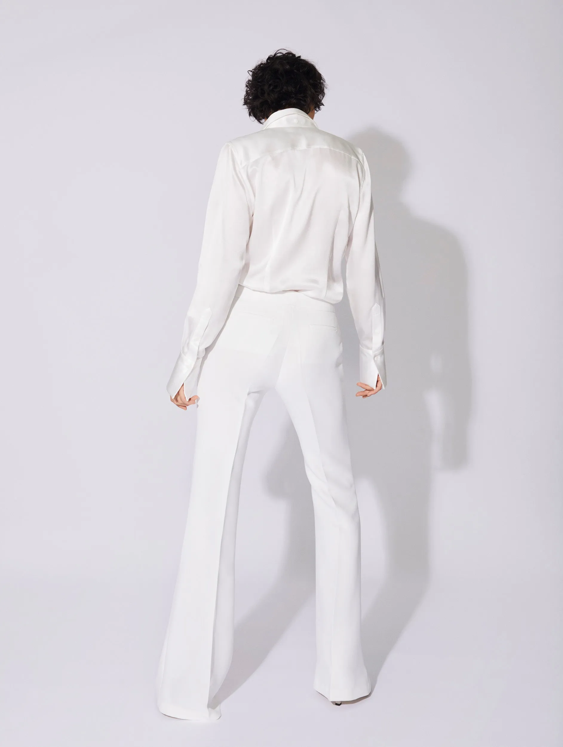 White crepe flared trousers with buckle